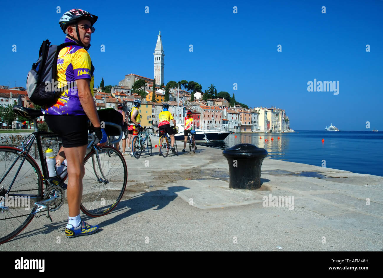 Di mezza età turismo in bicicletta sul pontile a Rovigno Istria Croazia Mare Adriatico Mare Mediterraneo n. MR Foto Stock