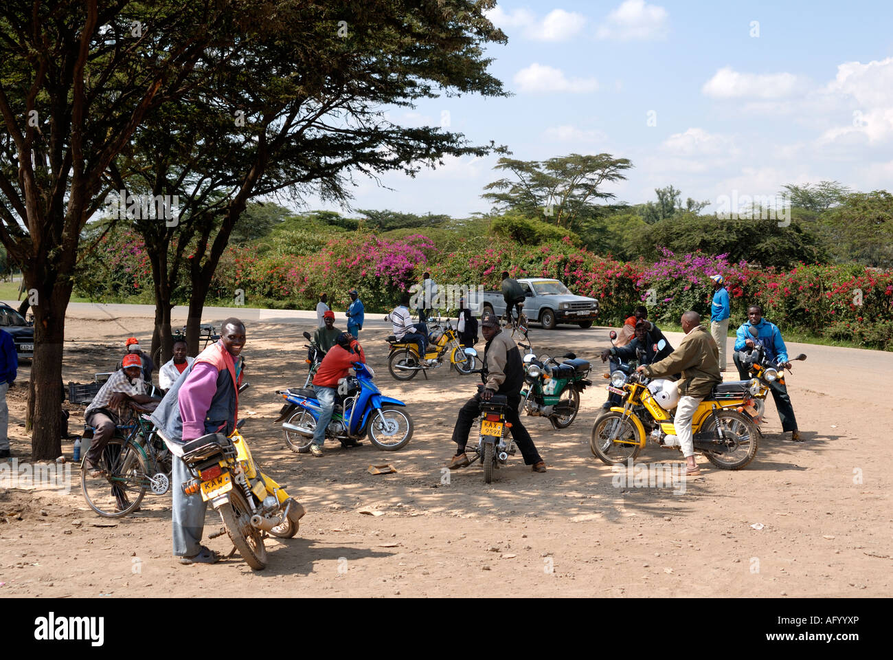 Un gruppo di giovani uomini con le motociclette parcheggiato a fianco del principale A109 road vicino al Rongai ad ovest di Nakuru Kenya Foto Stock