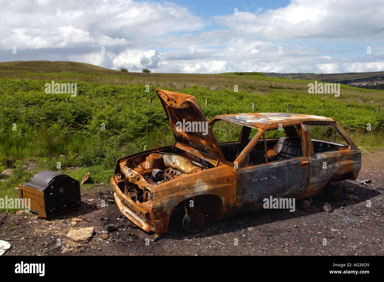 Furto di auto bruciata e oggetto di dumping in aperta campagna in South Wales UK Foto Stock