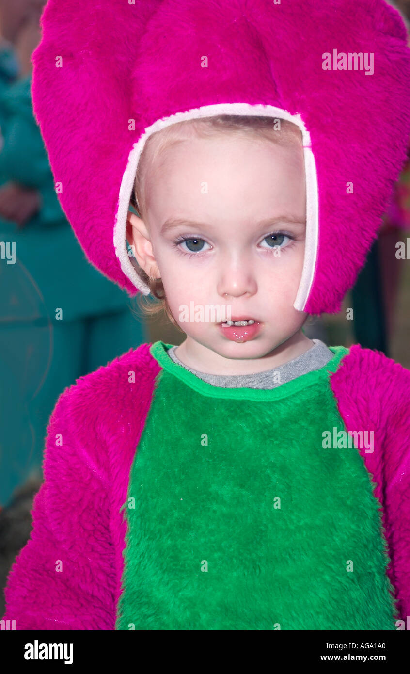 Un bambino vestito da Barney il dinosauro, l'amato personaggio viola della serie televisiva degli anni '1990. Foto Stock