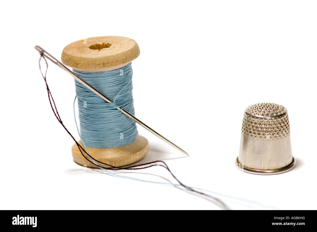 Oggetto di serie su bianco ditale con ago di cucitura Foto Stock