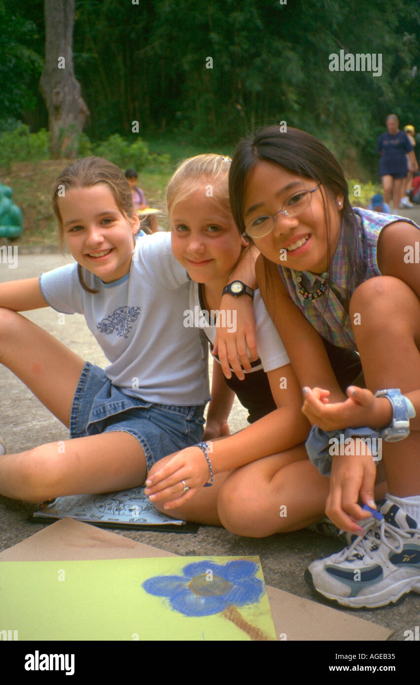 Asiatici e arte bianca gli studenti a scuola con i loro disegni ragazze età 11. Hong Kong Cina Asia Foto Stock