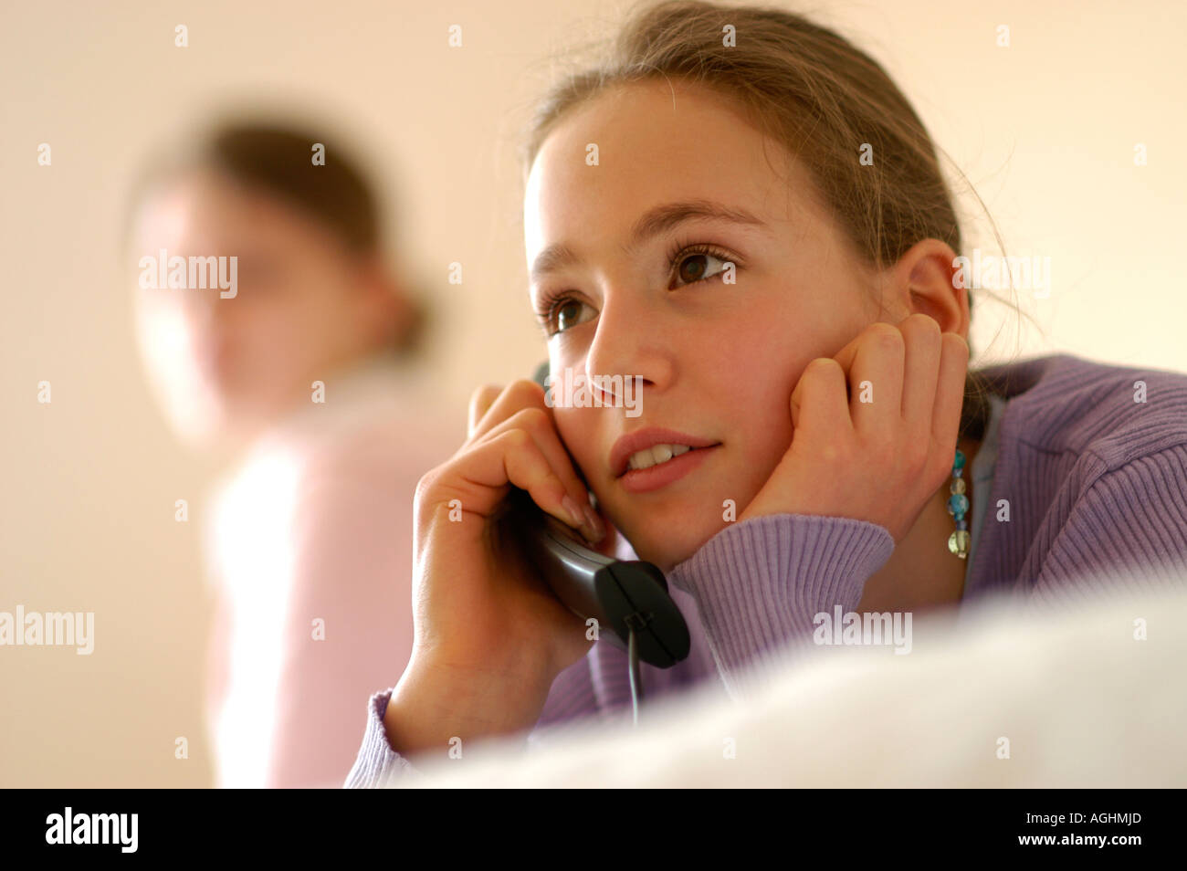 Ragazza adolescente guardando amico parlando al telefono Foto Stock