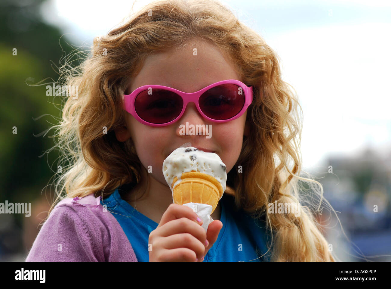 7 anno vecchia ragazza a mangiare il gelato, Surbiton, Londra, Regno Unito. Foto Stock