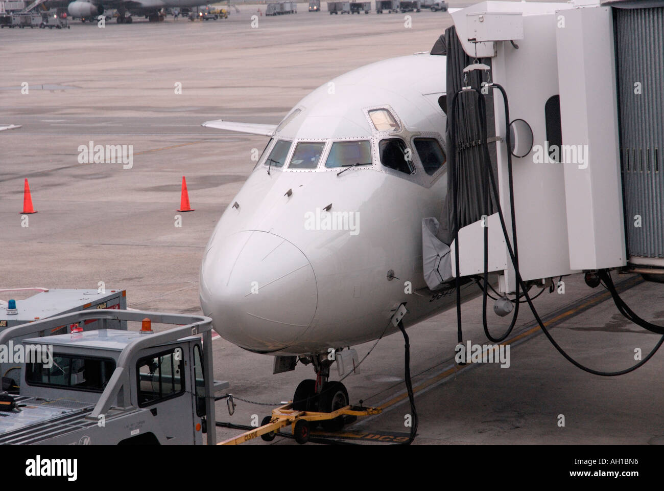 Naso di un aereo commerciale aereo di linea con ponte di imbarco fissato Foto Stock