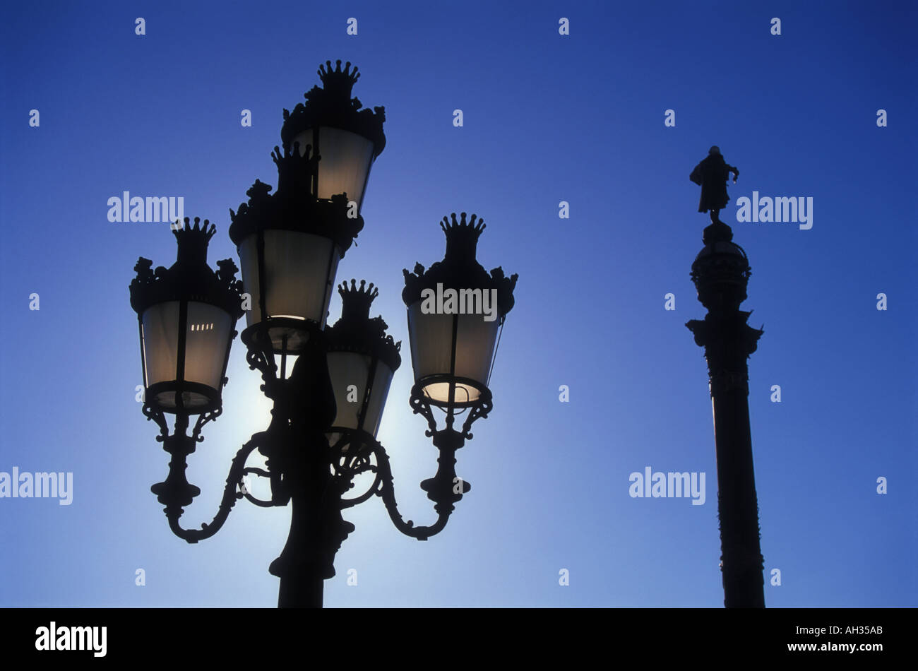 Lampade stradali e il monumento a Colombo a Barcellona Spagna Foto Stock