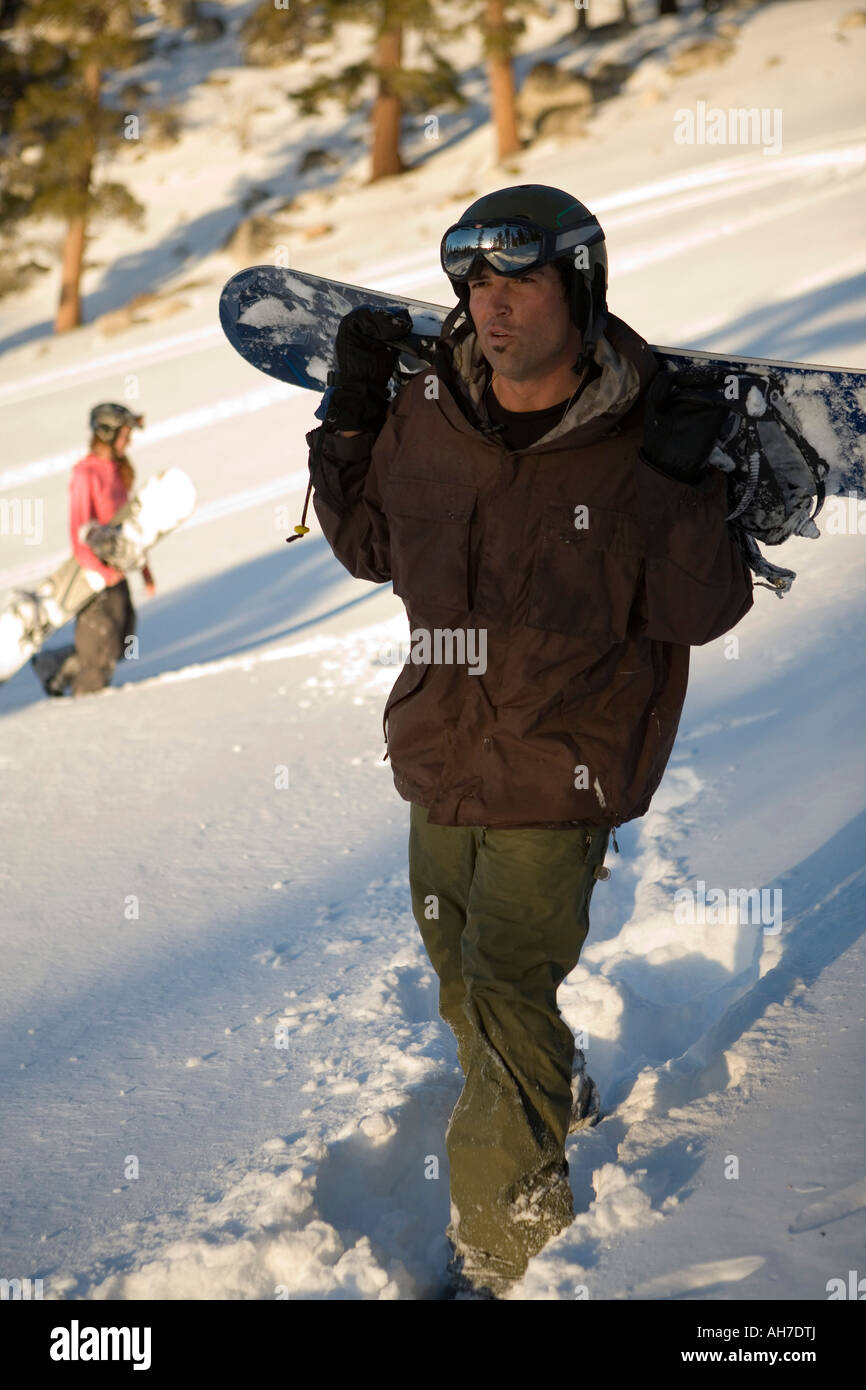 Metà uomo adulto che trasportano uno scarpone da snowboard Foto Stock