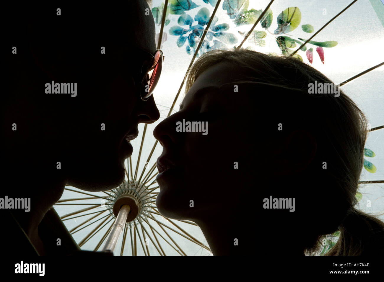 Silhouette di una giovane coppia di baciare ogni altro Foto Stock
