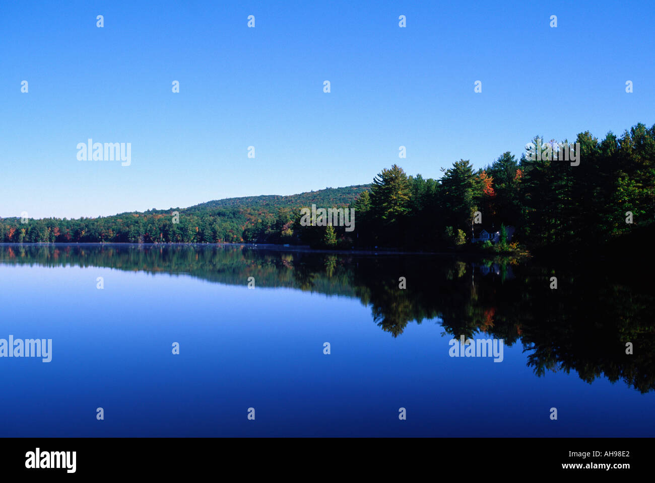 Autunno colline riflessa in un lago, New Hampshire Foto Stock