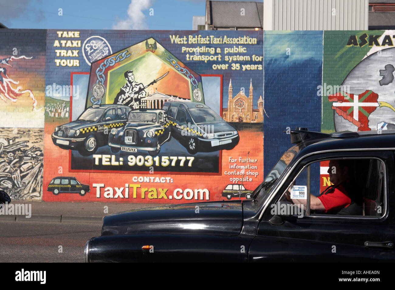 Falls Road taxi nero passato di guida internazionale di pitture murali di età repubblicana falls road area del west belfast Irel settentrionale Foto Stock