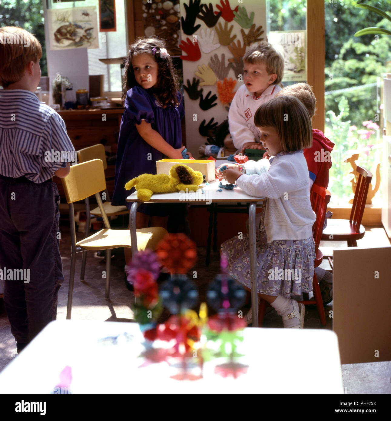 Un gruppo di bambini che giocano insieme a un tavolo interno in una scuola materna di Isola di Vancouver, British Columbia, Canada KATHY DEWITT Foto Stock