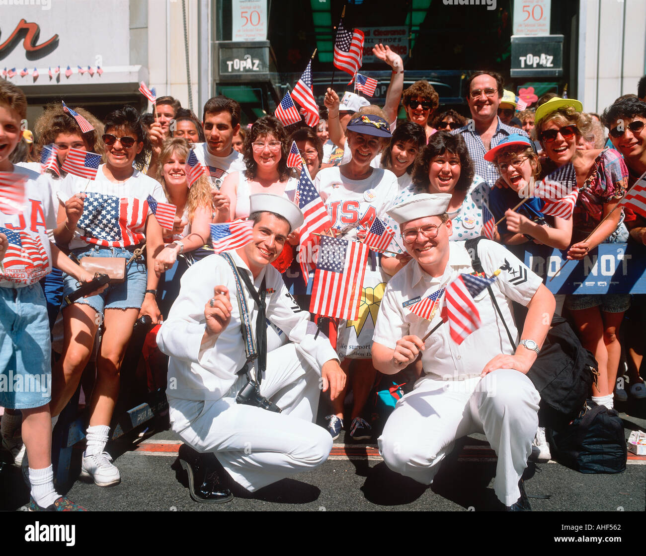 I marinai e la folla sventolando bandierine americane presso il Desert Storm Victory Parade di New York City New York Foto Stock