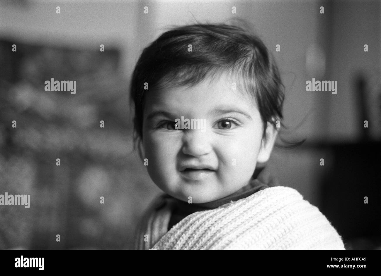 Un giovane di 2 anno vecchia ragazza smorfie per la fotocamera a casa. Foto Stock