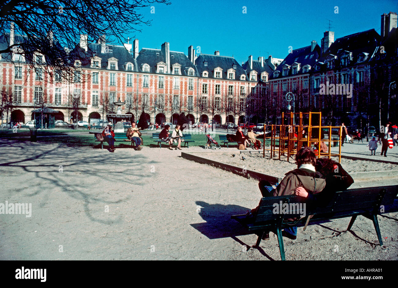 Parigi Francia Parchi posteriori, coppia sulla panchina in 'Place des Vosges' le Marais quartiere uomo Donna al di fuori del Giardino della Gioventù Foto Stock