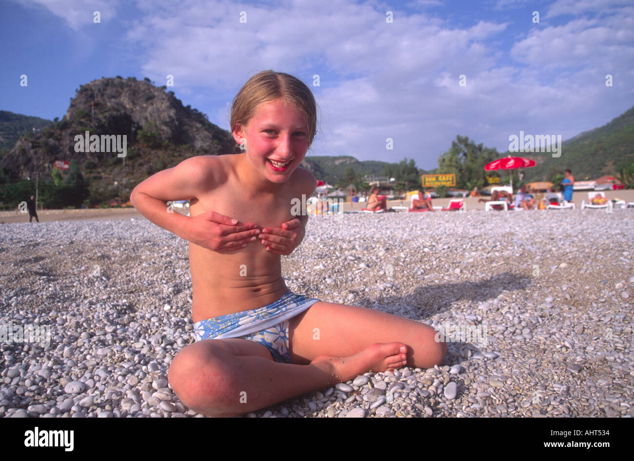 Ragazza giovane cerca timido sulla spiaggia che copre i suoi capezzoli con  le sue mani e sorridente Oludeniz Turchia Foto stock - Alamy