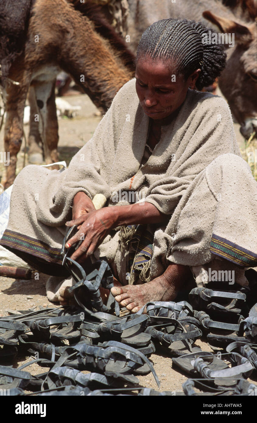 La donna la realizzazione e la vendita di sandali realizzati da vecchi pneumatici. Mahoney,Tigray, Etiopia Foto Stock