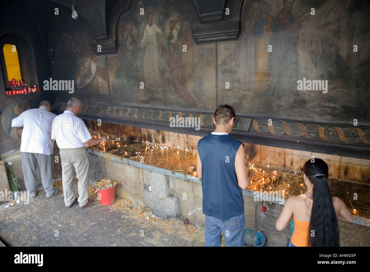 I credenti infiammando candele di fronte rumeno della Cattedrale Patriarcale a Bucarest / Romania Foto Stock
