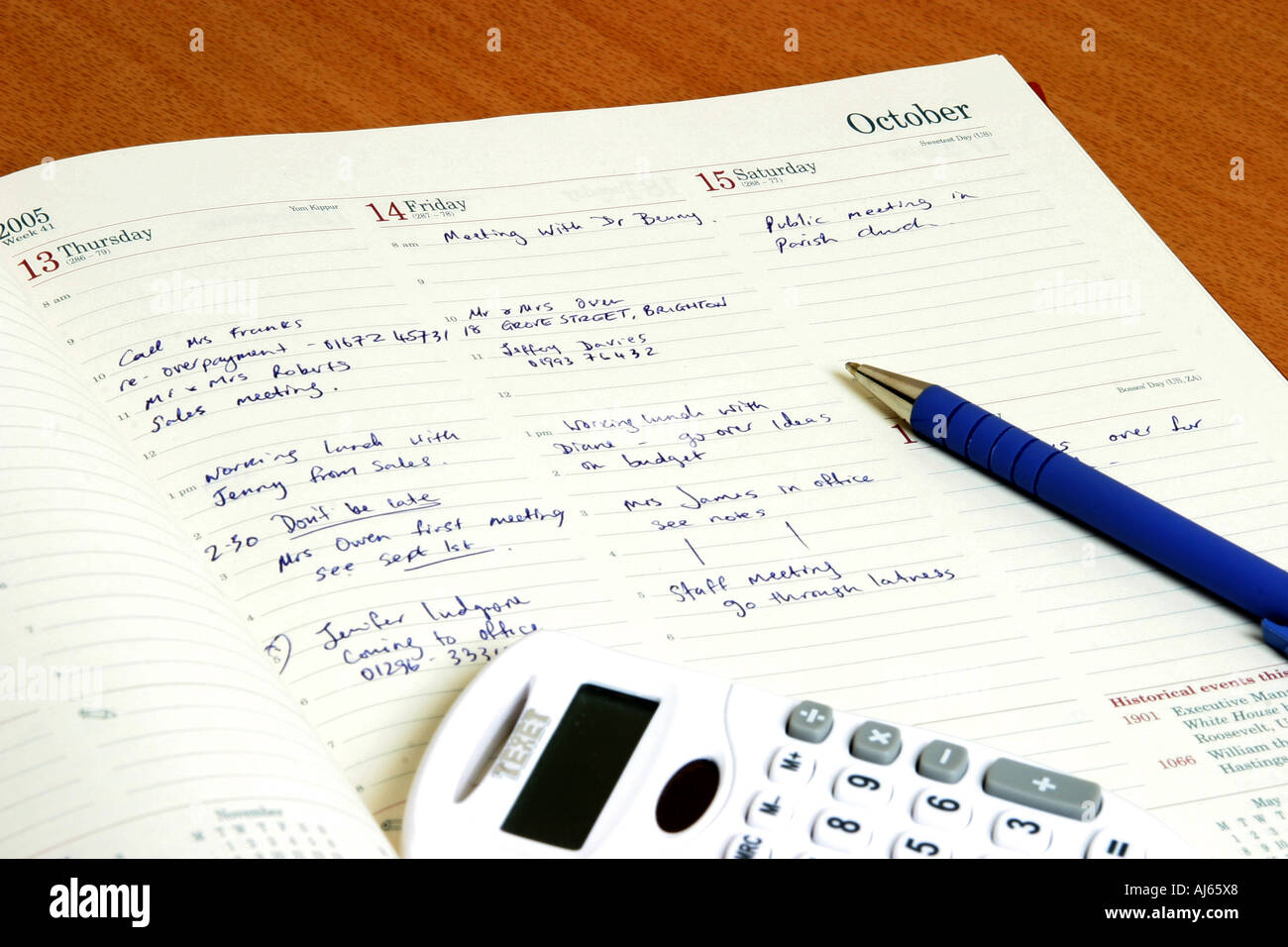Un diario aperto con una penna e una calcolatrice. Foto Stock