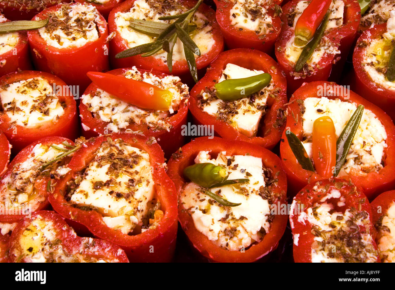 La paprica rossa pepe bell riempito di latte ovino formaggio feta feta formaggio di capra e herbes gratinato Foto Stock