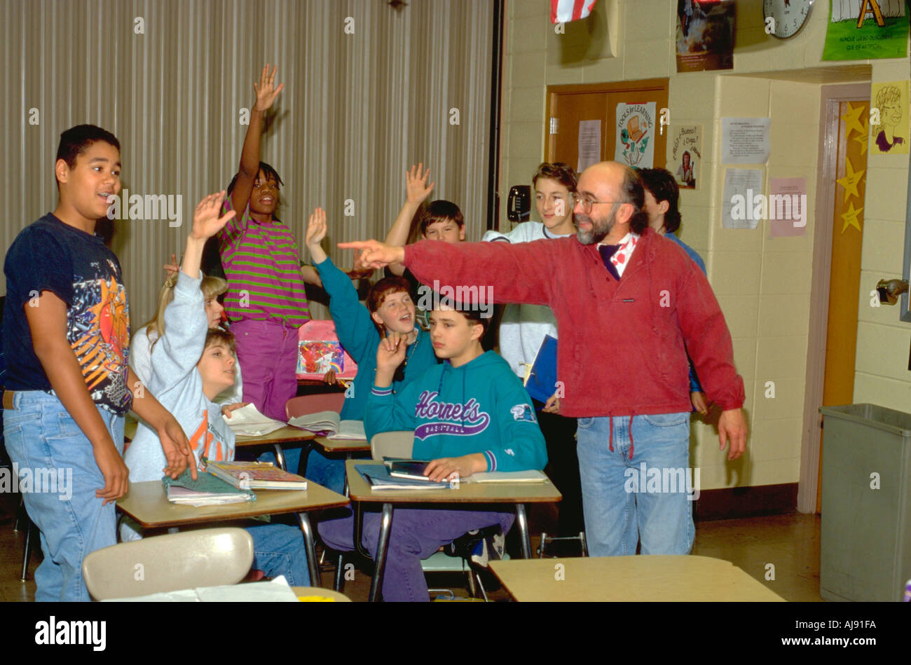 E insegnante di lingua spagnola gli studenti con le mani fino età 50 e 14. Golden Valley Minnesota USA Foto Stock