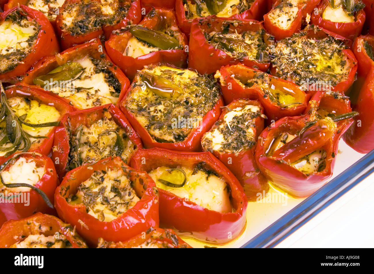 La paprica rossa pepe bell riempito di latte ovino formaggio feta feta formaggio di capra e herbes gratinato Foto Stock