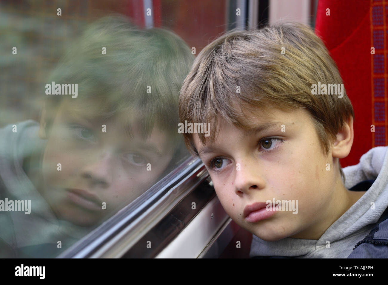 Ragazzo giovane di età compresa tra 11 anni cercando triste infelice che viaggiano in treno Foto Stock