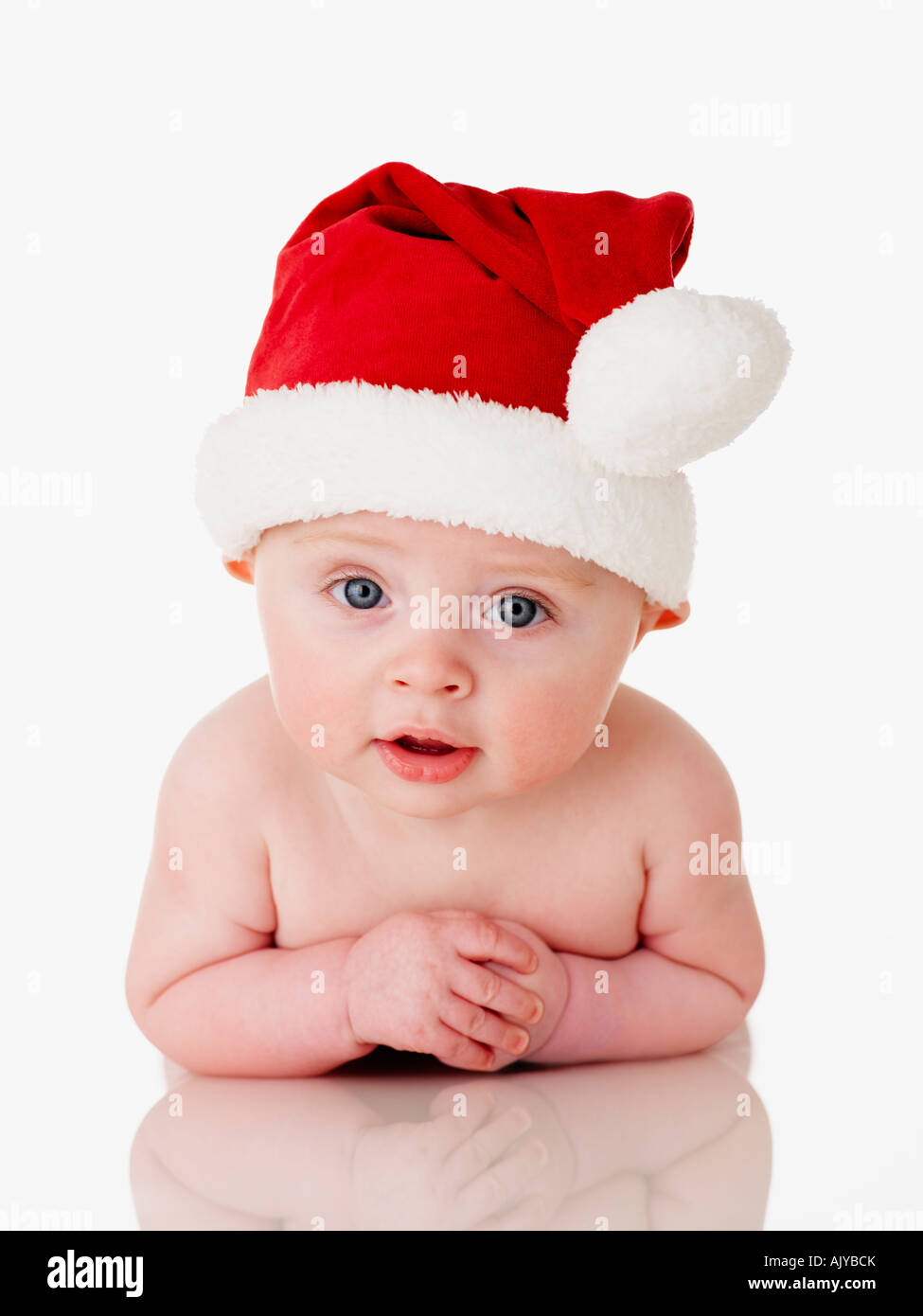 Formato ritratto foto di un simpatico baby in Santa Babbo Natale Hat in perspex bianco contro sfondo bianco Foto Stock