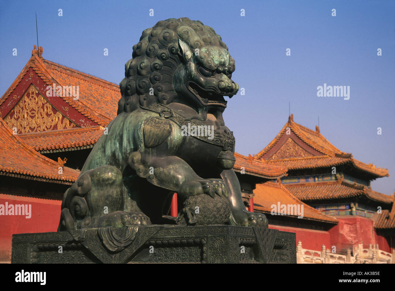 Leone di Bronzo statua con architettura tradizionale nella Città Proibita di Pechino CINA Foto Stock