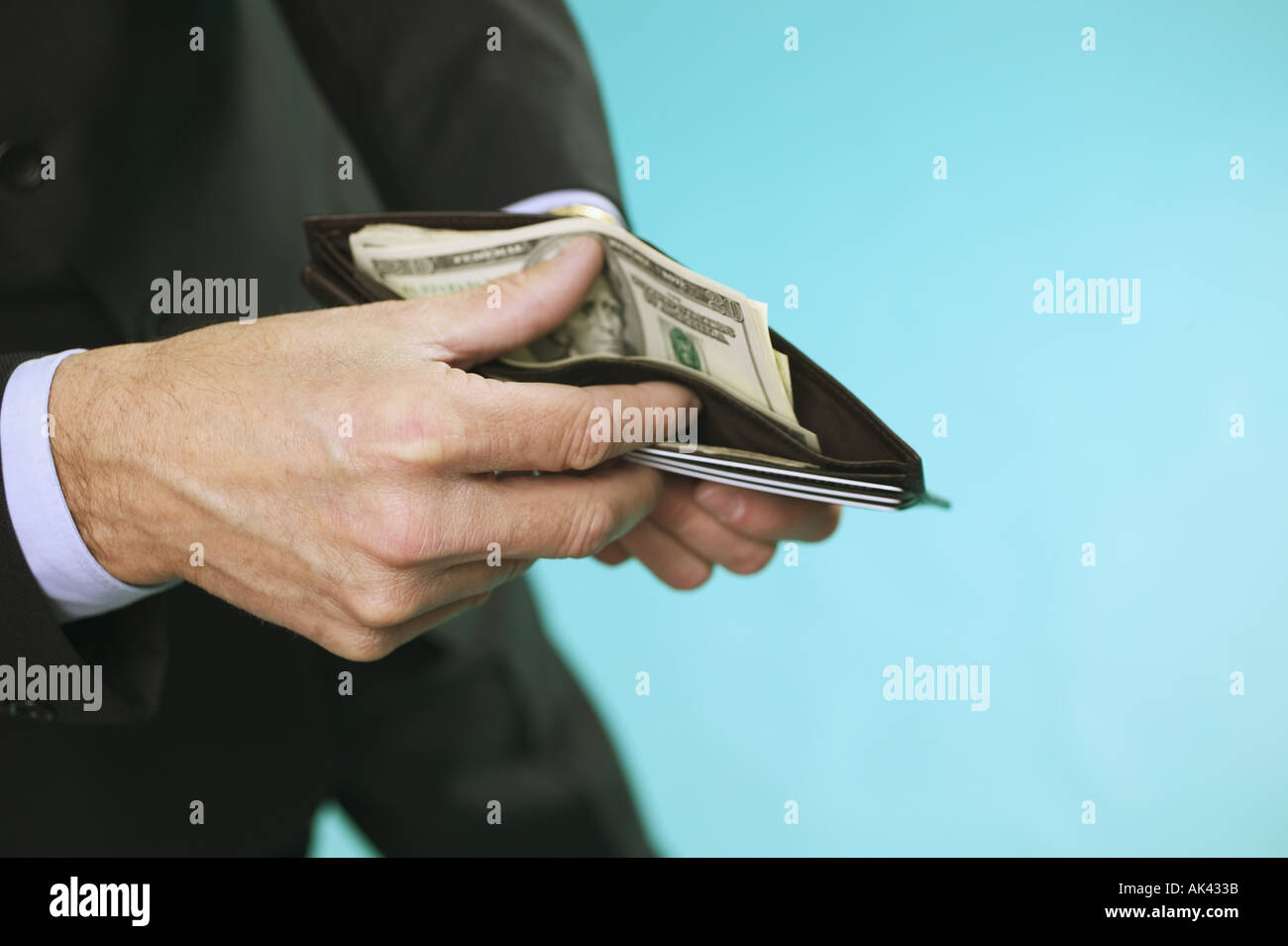 L'uomo controllare i contanti nel suo portafogli Foto Stock