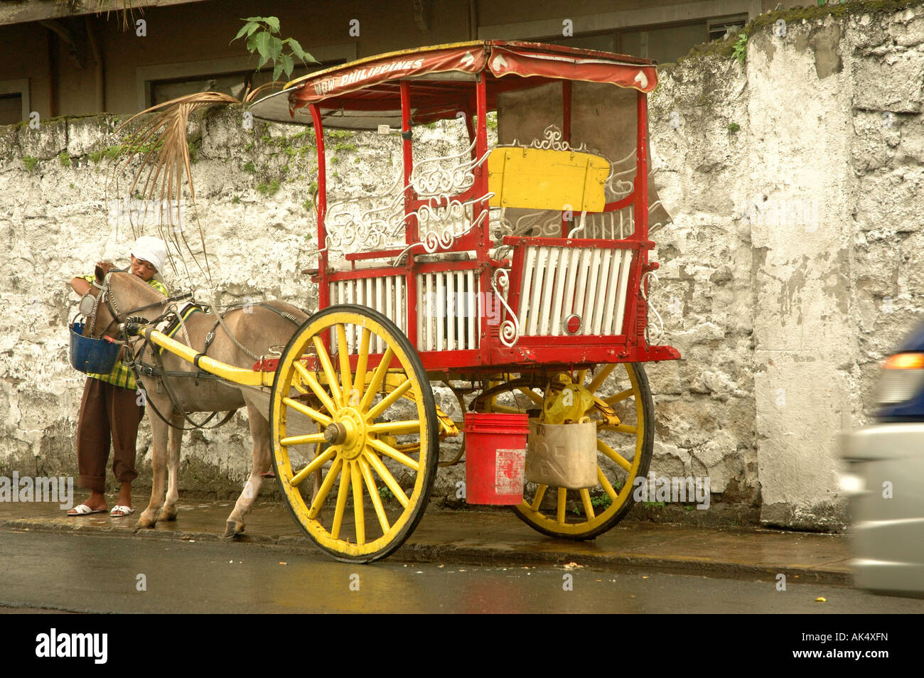 Vecchio cavallo e carrello passante bianco edificio coloniale in Intramuros, Manila Foto Stock