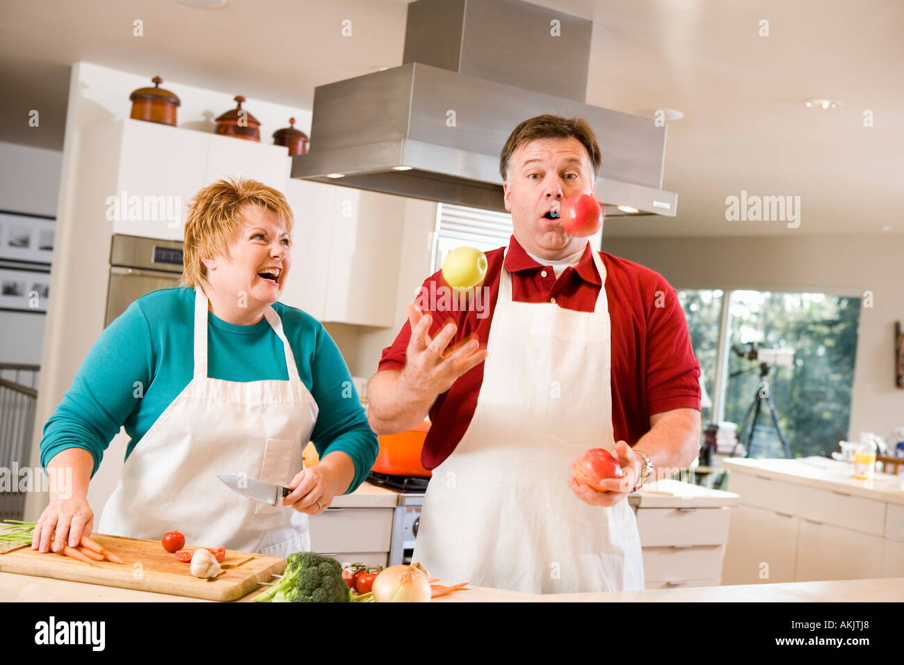 Il marito di giocoleria con frutta ridere moglie Foto Stock