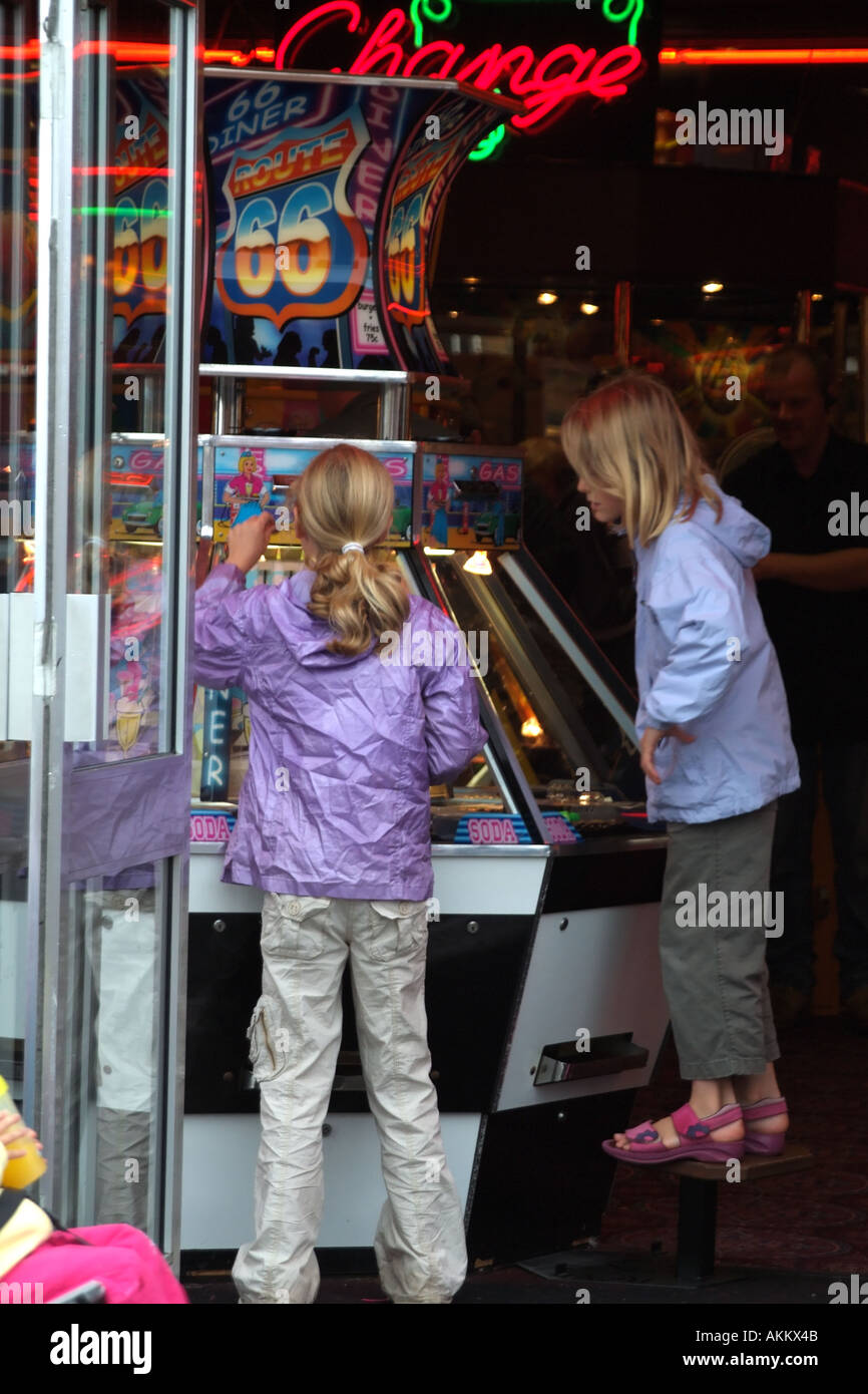 I bambini a giocare le slot machines utilizzando i loro pocketmoney EUROPEO DEL REGNO UNITO Foto Stock