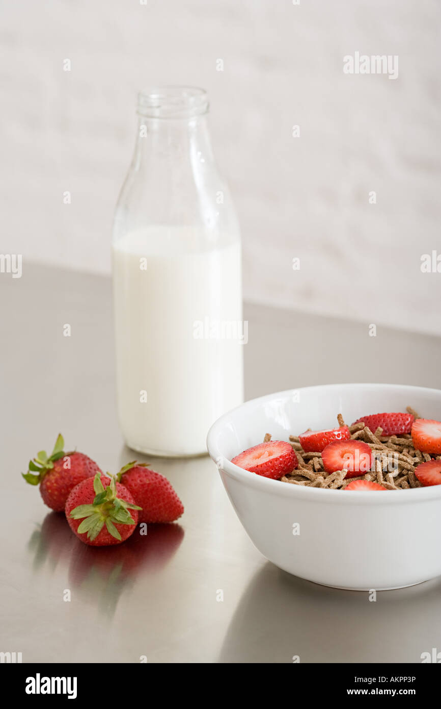 Una ciotola di cereale e una bottiglia di latte Foto Stock
