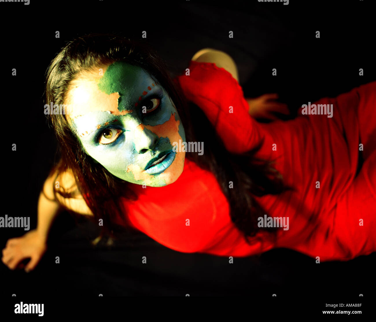 Straniero in un abito rosso verde con peeling viso Foto Stock