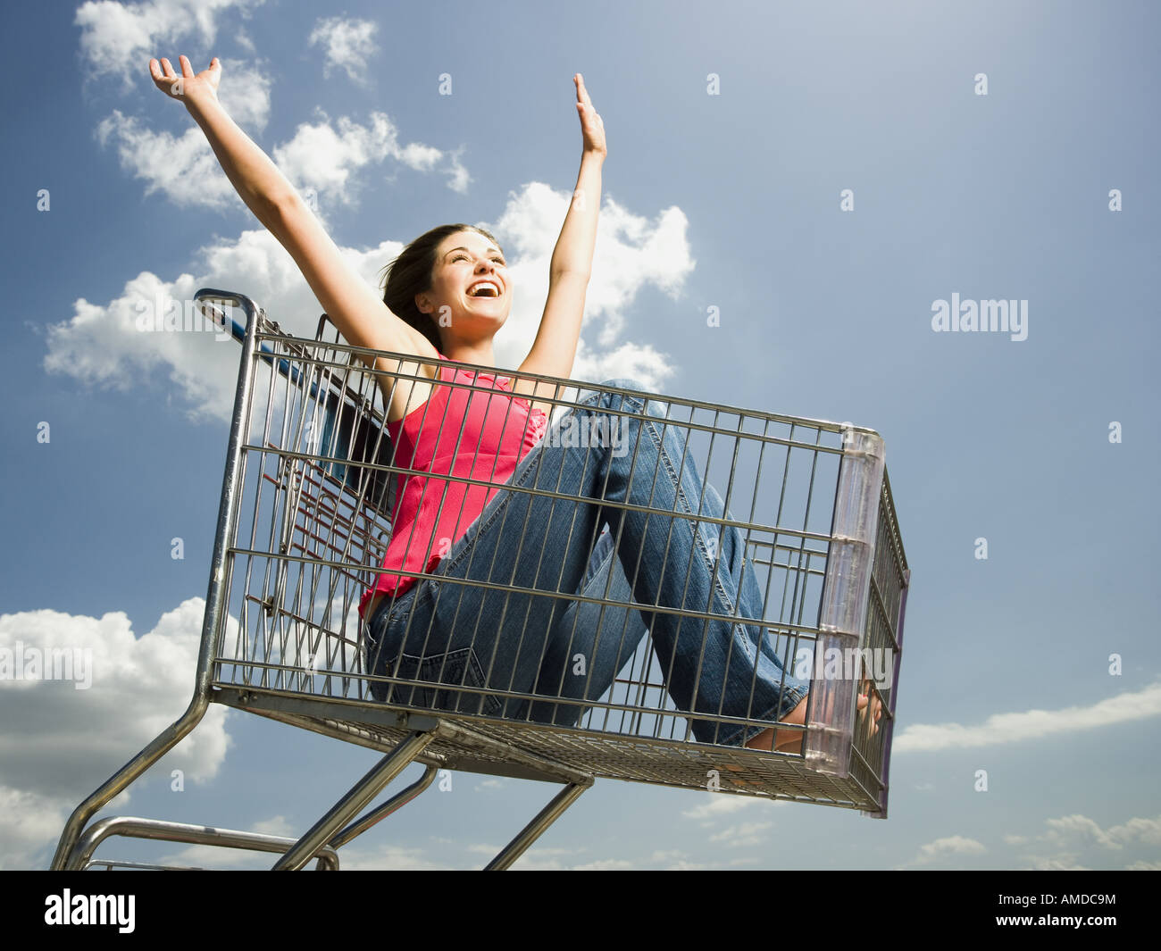 La donna nel carrello aperto con bracci fino a sorridere Foto Stock