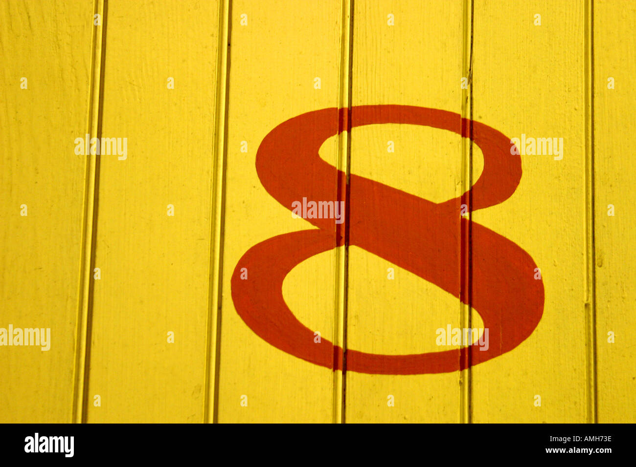 Numero otto luminoso con sfondo giallo Foto Stock