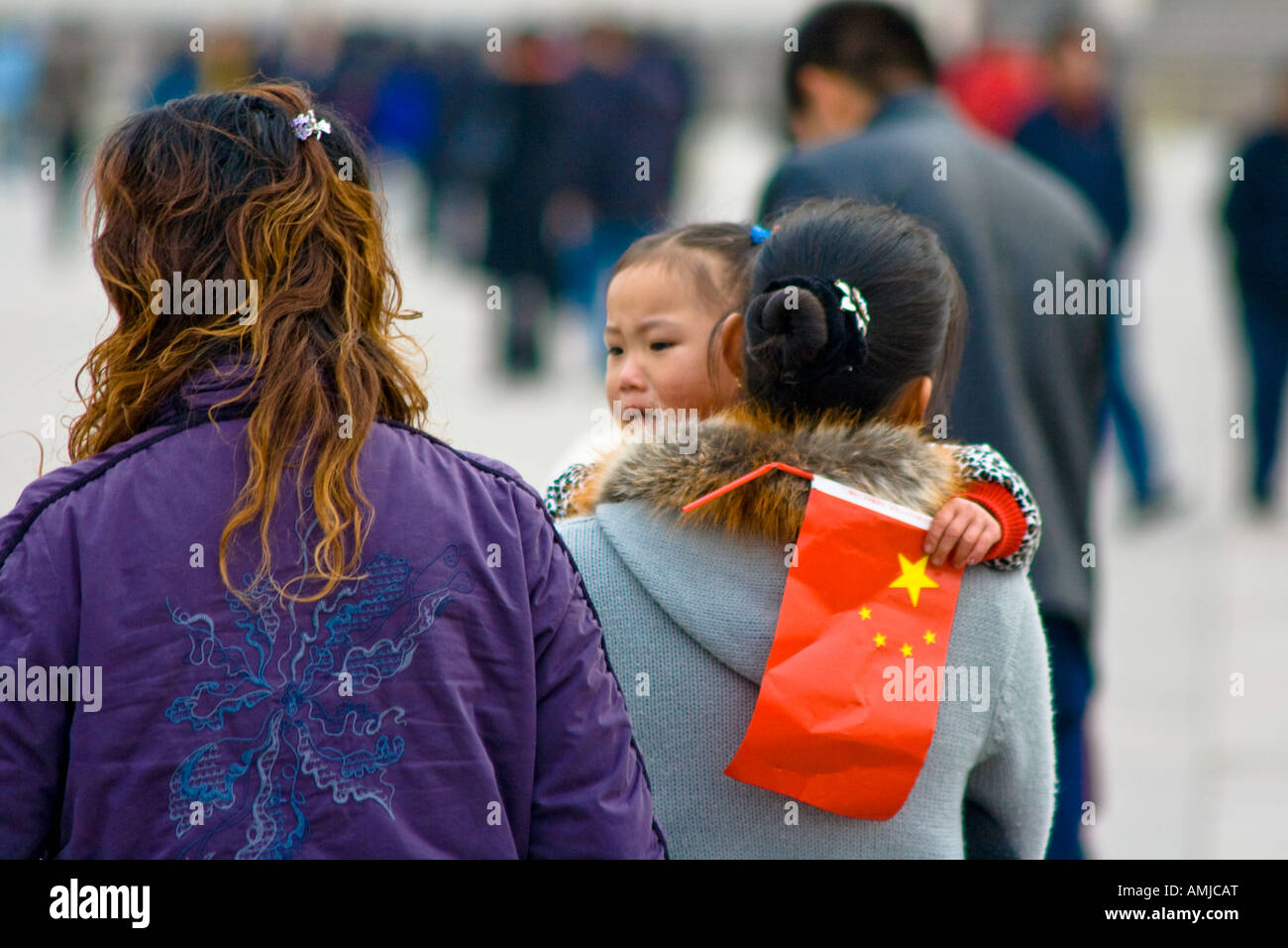 Giovane ragazza cinese e sua madre con bandiera nazionale Piazza Tiananmen Pechino CINA Foto Stock