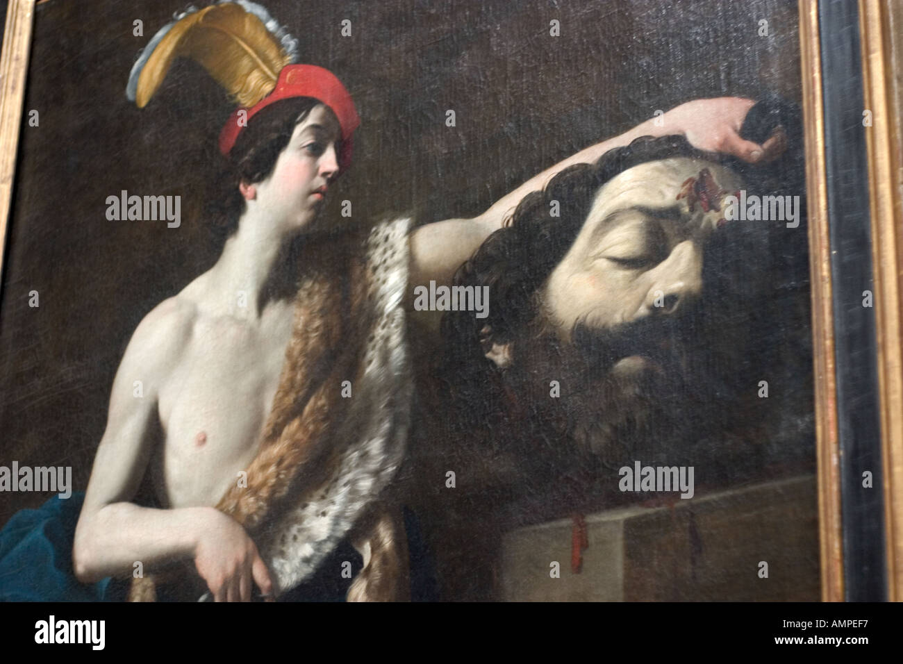 Un dipinto del museo del Louvre a Parigi Francia raffigura un fanciullesco David in un cappello piumati tenendo la testa di spurgo di Golia Foto Stock