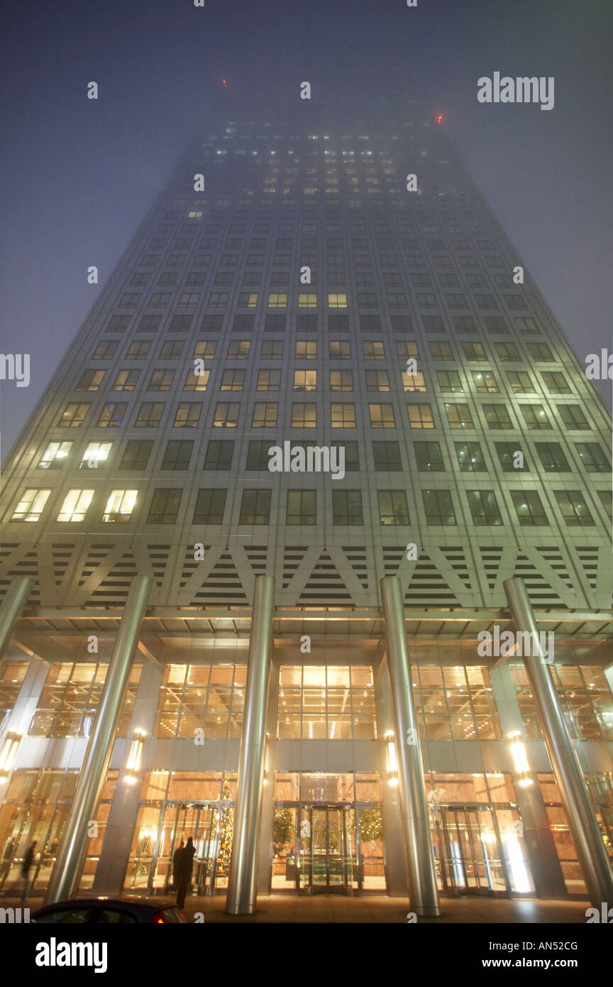 Vista notturna di One Canada Square office edificio che sorge nella nebbia, a Canary Wharf Docklands Londra REGNO UNITO Foto Stock