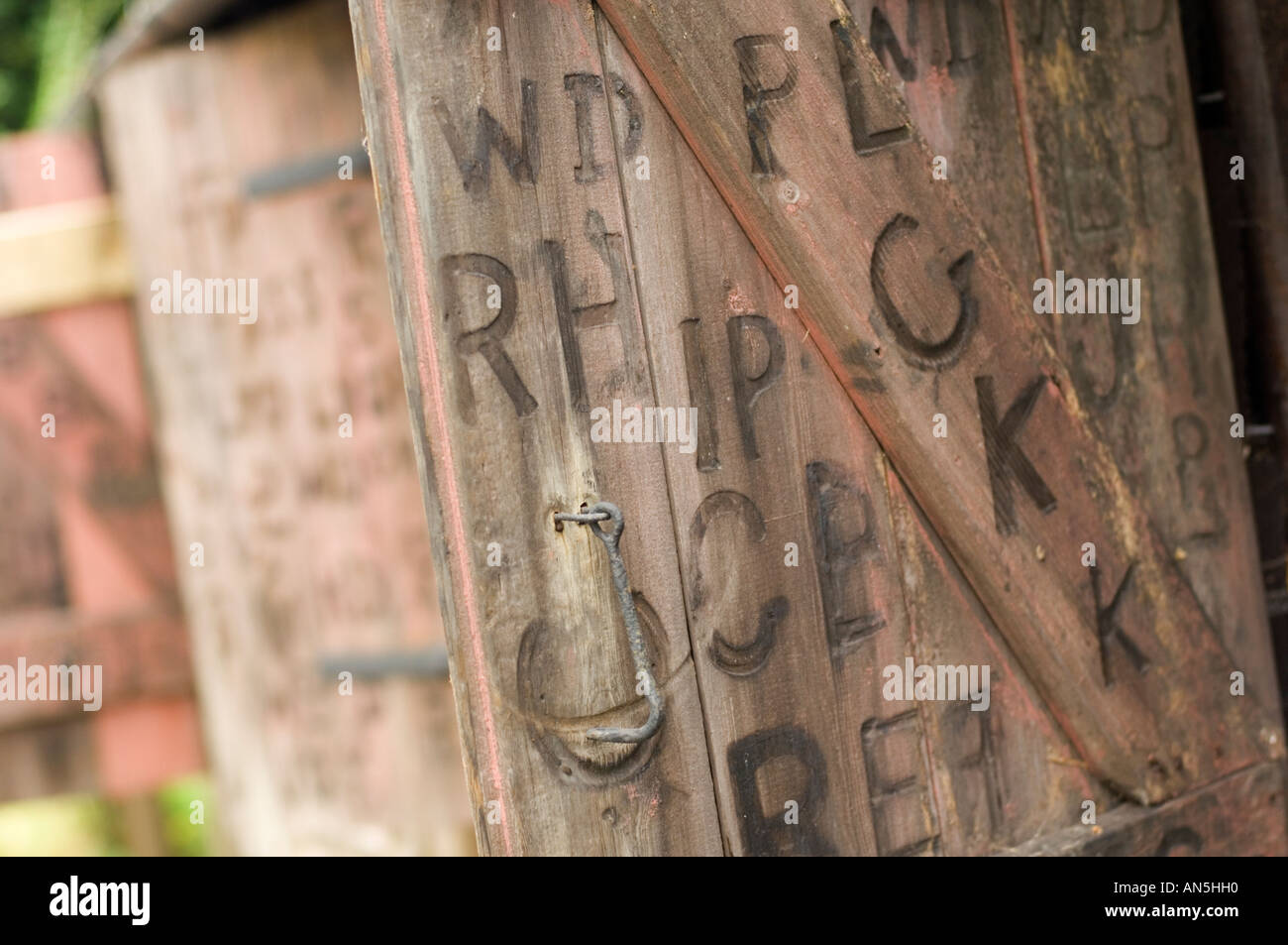 Persiane di legno sul vecchio fabbro Penybont shop Powys Wales UK, con segni di marca di lettere e simboli costituiti da Smith Foto Stock