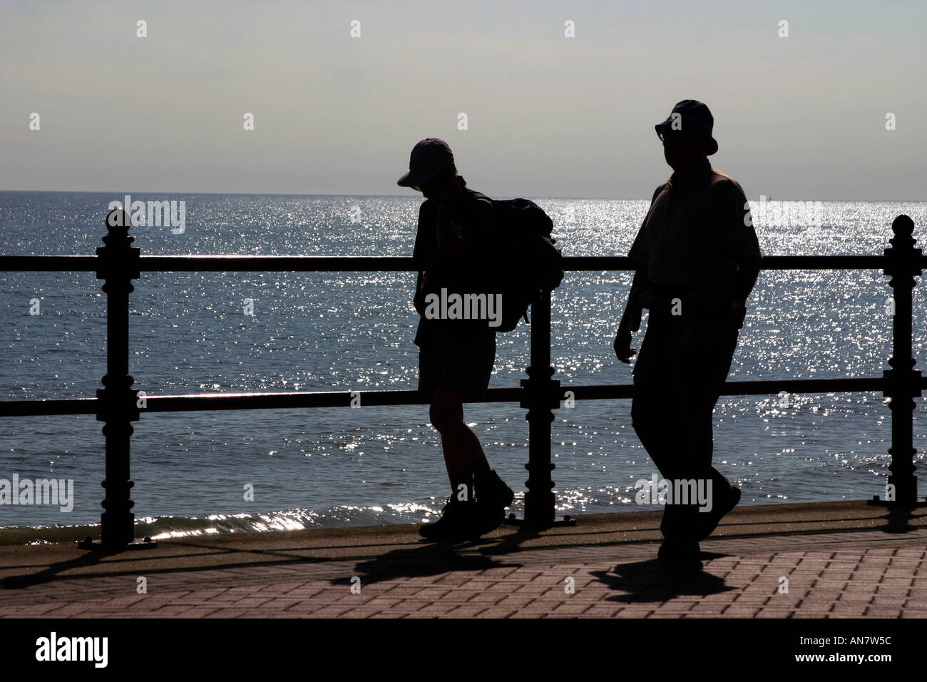 Silhouette di giovane camminando lungo il lungomare di Bridlington Yorkshire del Nord Foto Stock