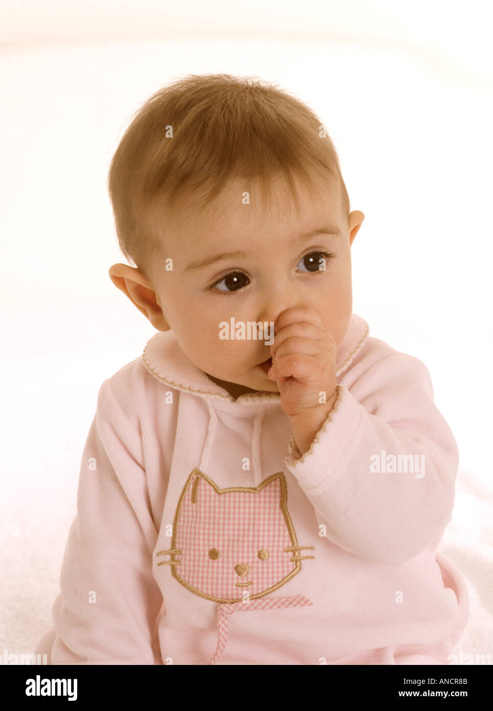 Baby girl succhiare il suo pollice Foto Stock