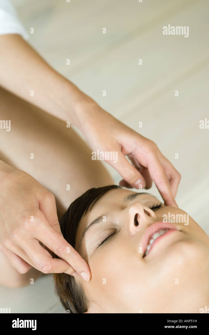 Giovane donna ricevere massaggio della testa Foto Stock