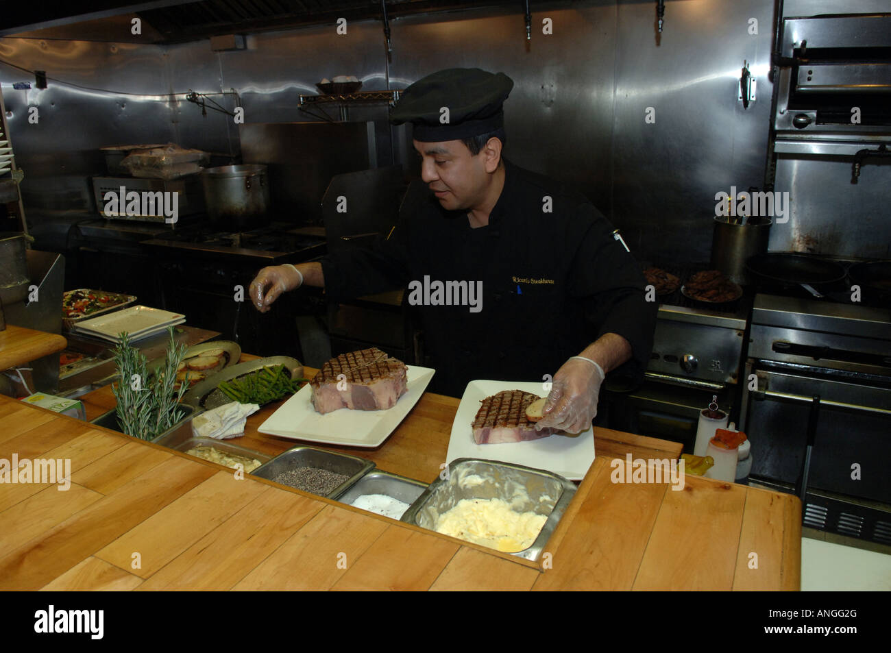 Lo chef prepara osteria bistecca al Ricardo Steak House East Harlem in NYC Foto Stock