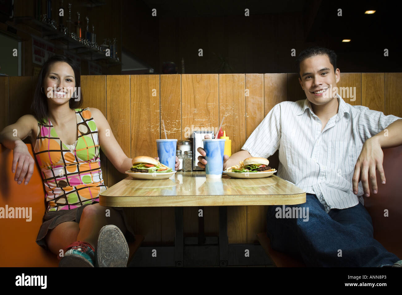 Ritratto di un giovane uomo e una ragazza seduta in un ristorante Foto Stock