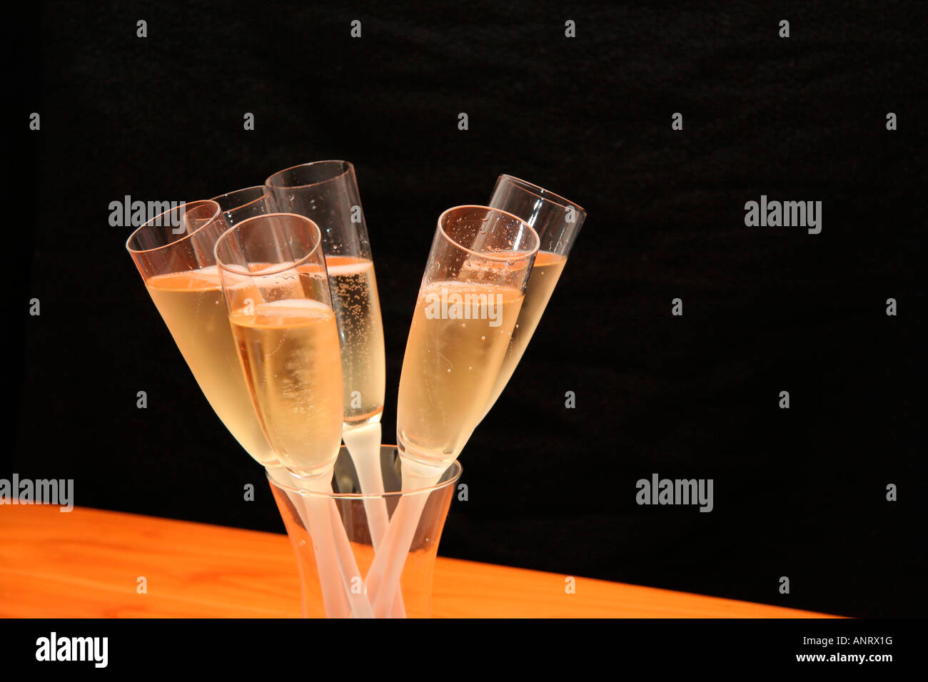 Bicchieri di champagne footloose messo in un vaso recipiente Criss Crossed Foto Stock