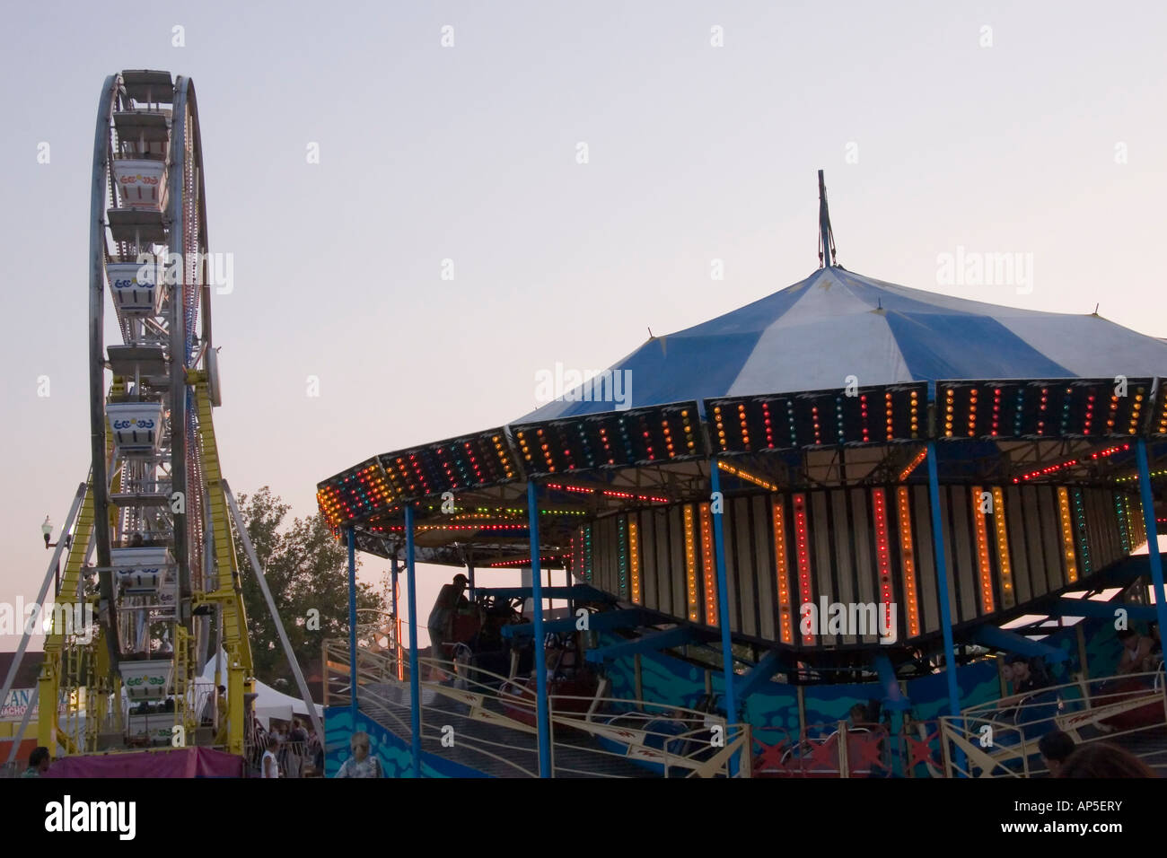 Qui ci sono 2 tipi diversi di Amusement Park rides: il tradizionale, easy-going ruota panoramica Ferris & 'spin till you drop' tipo. Foto Stock