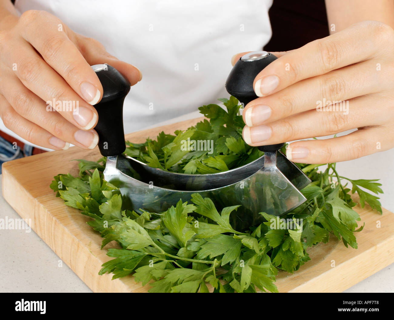 La donna in cucina tritare il prezzemolo con HACHOIR / Mezzaluna Foto stock  - Alamy