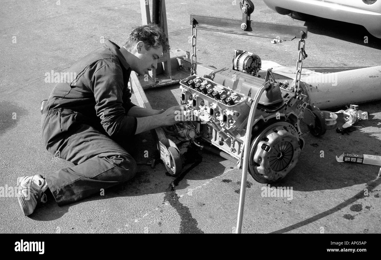 Lavoro meccanico sul motore da corsa fuori della vettura ai box a Cadwell Park. Foto Stock