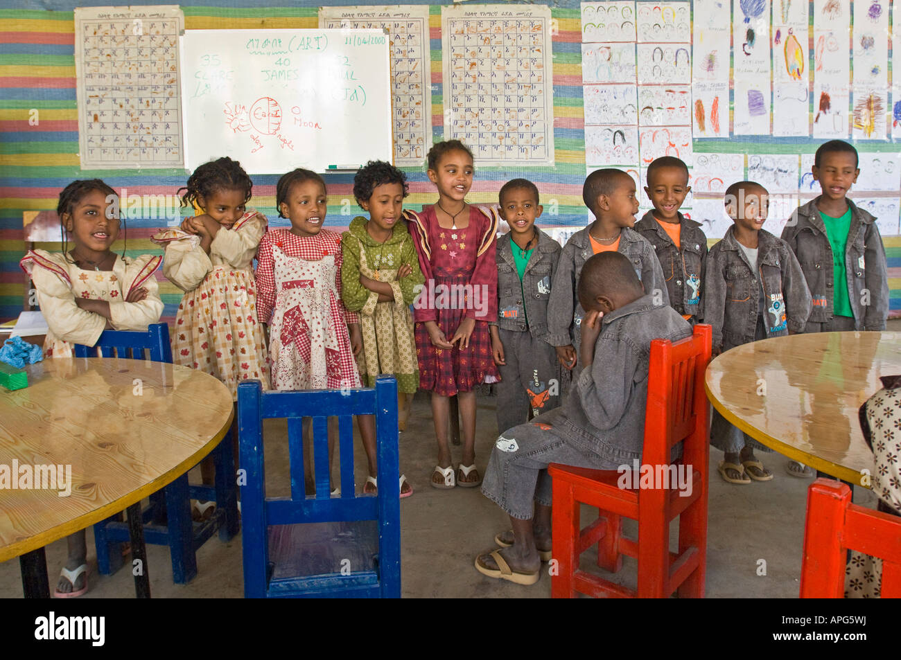 Bambini cantano una canzone in aula di una carità eseguire scuola. Foto Stock
